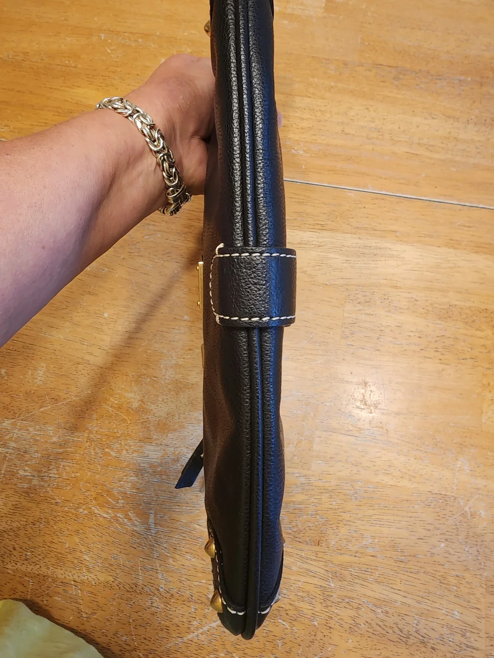 vintage Dooney & Bourke black leather shoulder bag featuring gold-tone hardware